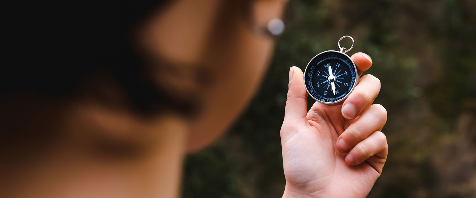 Person holding a compass